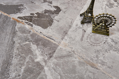 Dark colored ceramic tiles, marble tiles throughout the living room
